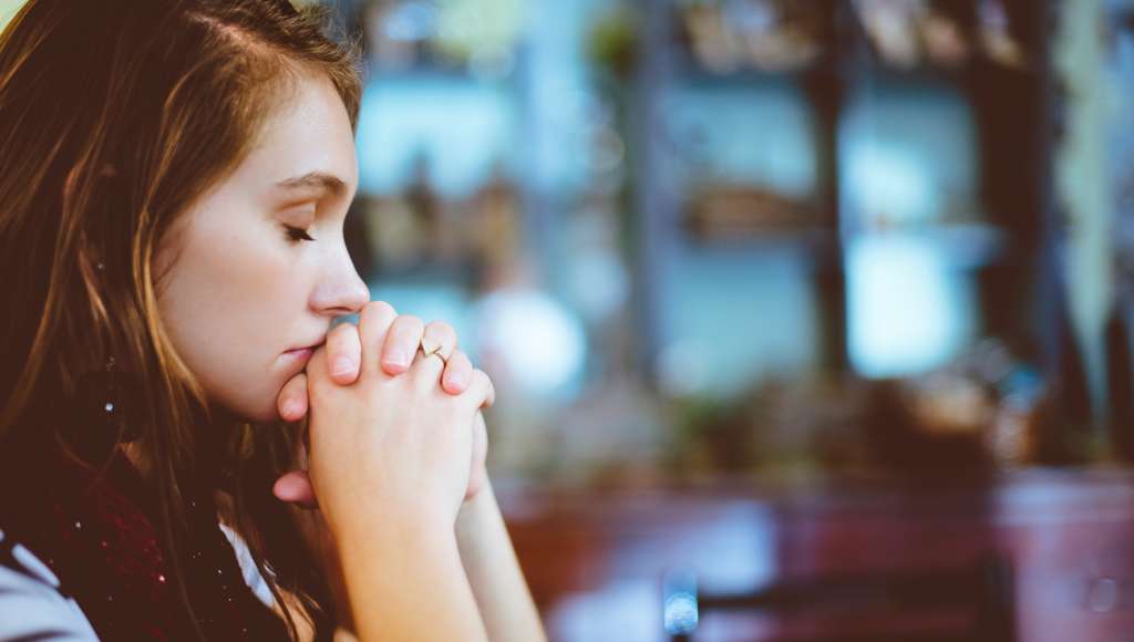 Praying young woman