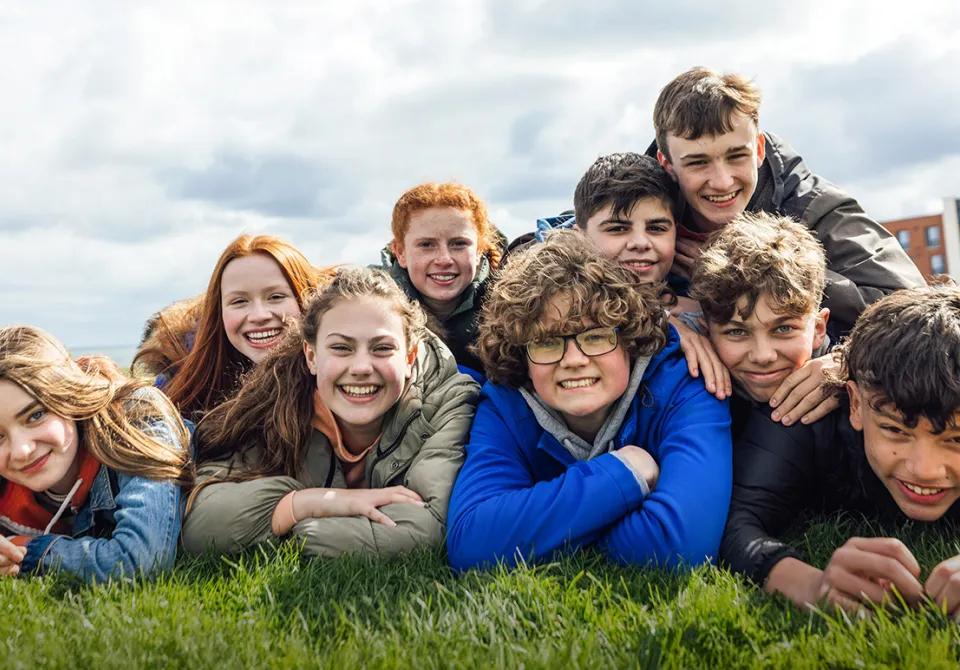 Group of teenagers laying on the grass