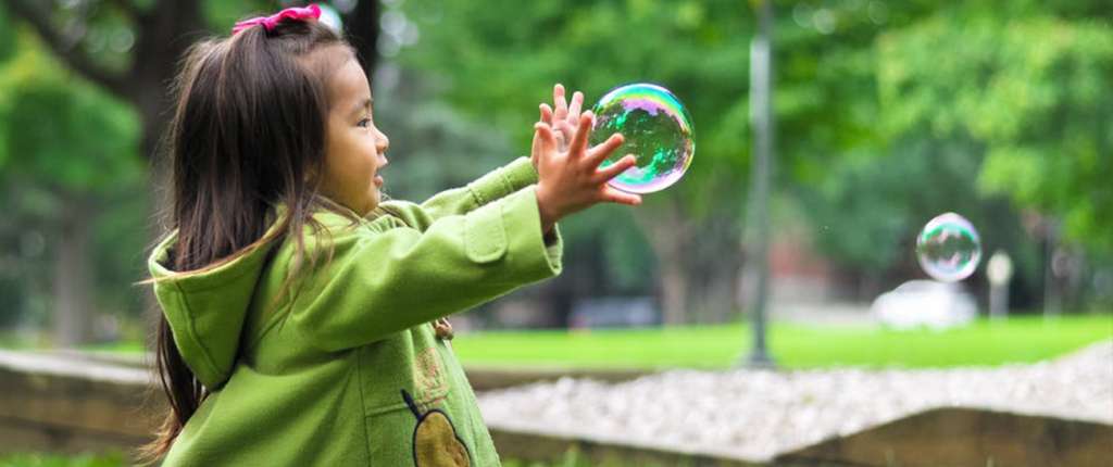 Girl chasing bubbles