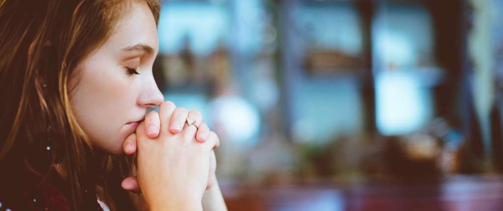Praying young woman