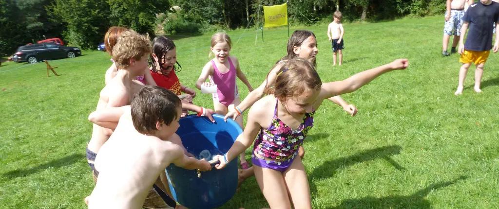 Children with bucket of water - summer holiday