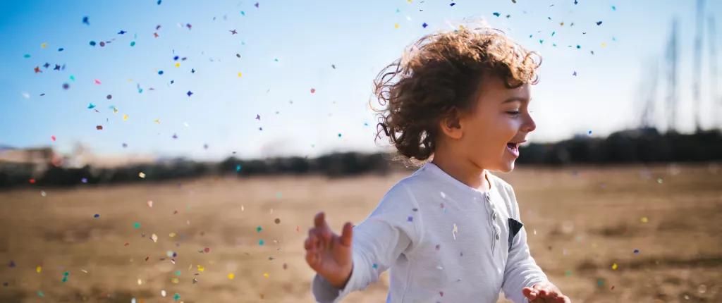 boy-on-a-beach-with-confetti