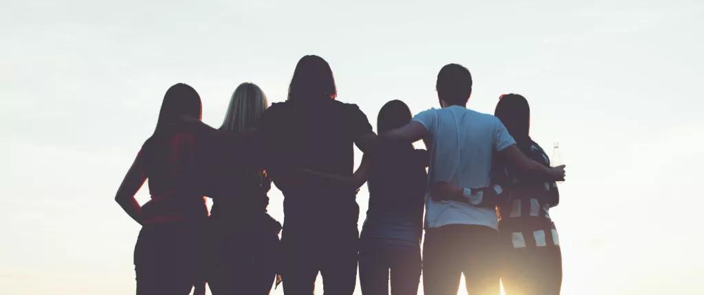 Young people with arms around each other