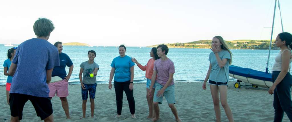 young people playing on beach
