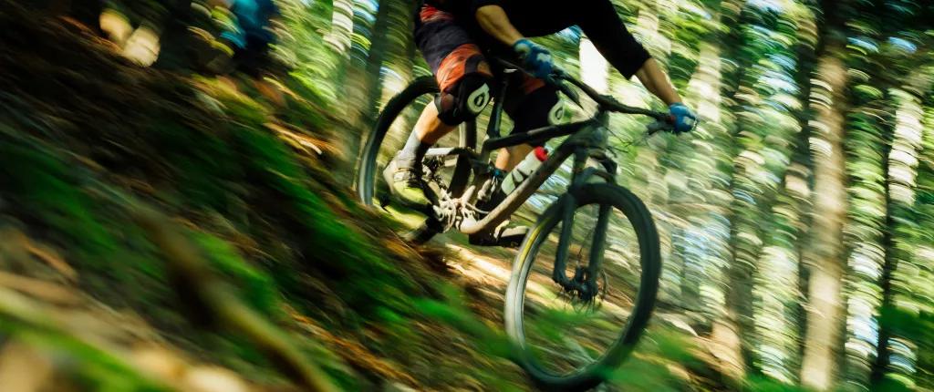Mountain biker racing down a slope