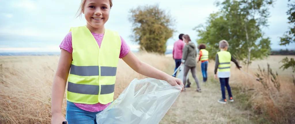 Child holding bag for litter picking
