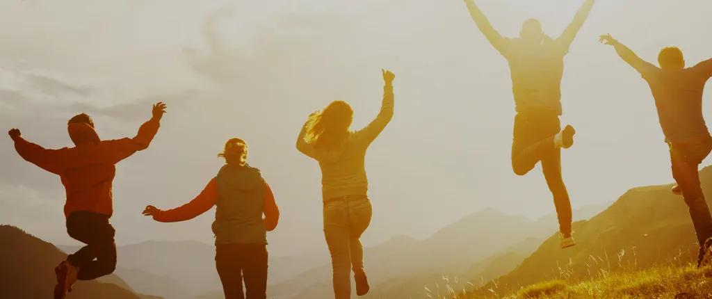 Teenagers jumping at sunset