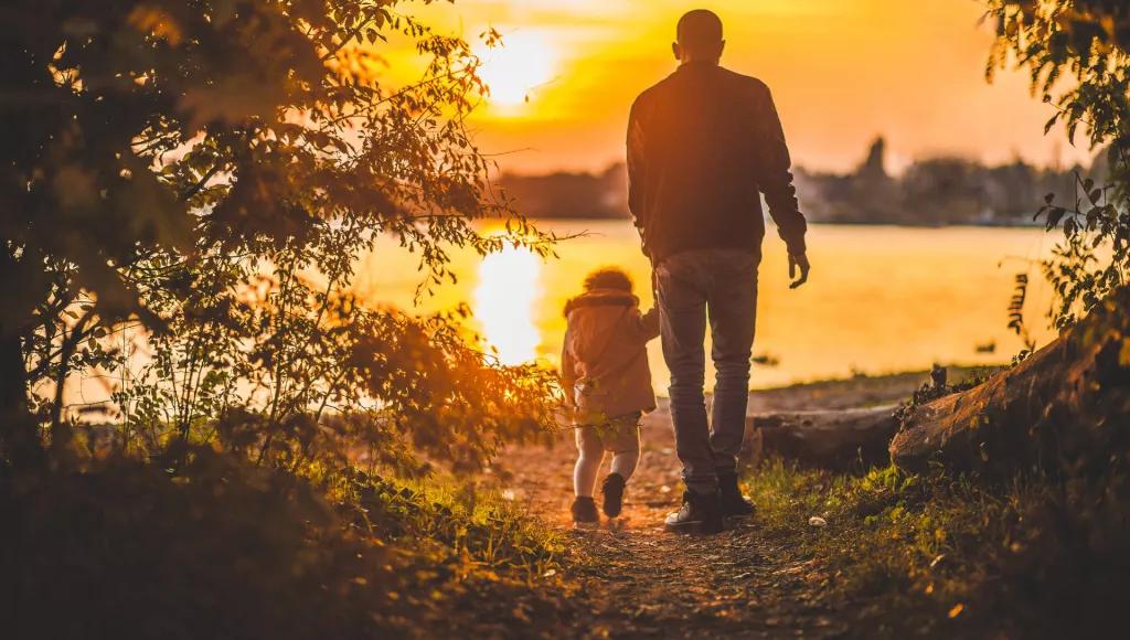 Adult and child holding hands