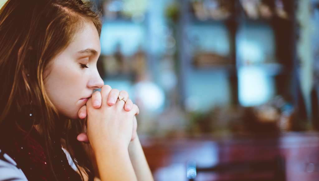 Praying young woman