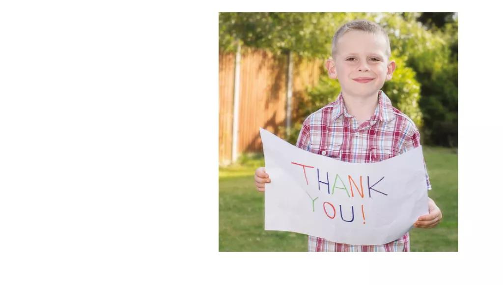 Boy holding thank you sign