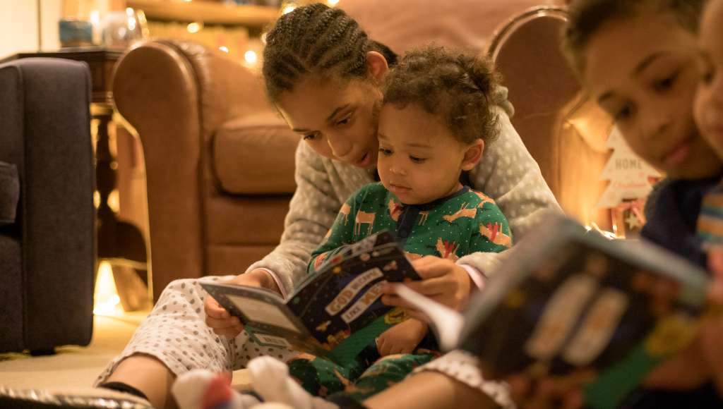 Children reading God Became Like Me Children reading God Became Like Me