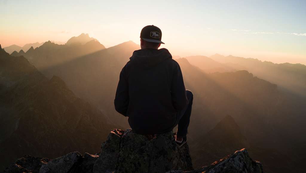 Youth in baseball cap on mountain