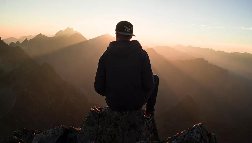 Youth in baseball cap on mountain