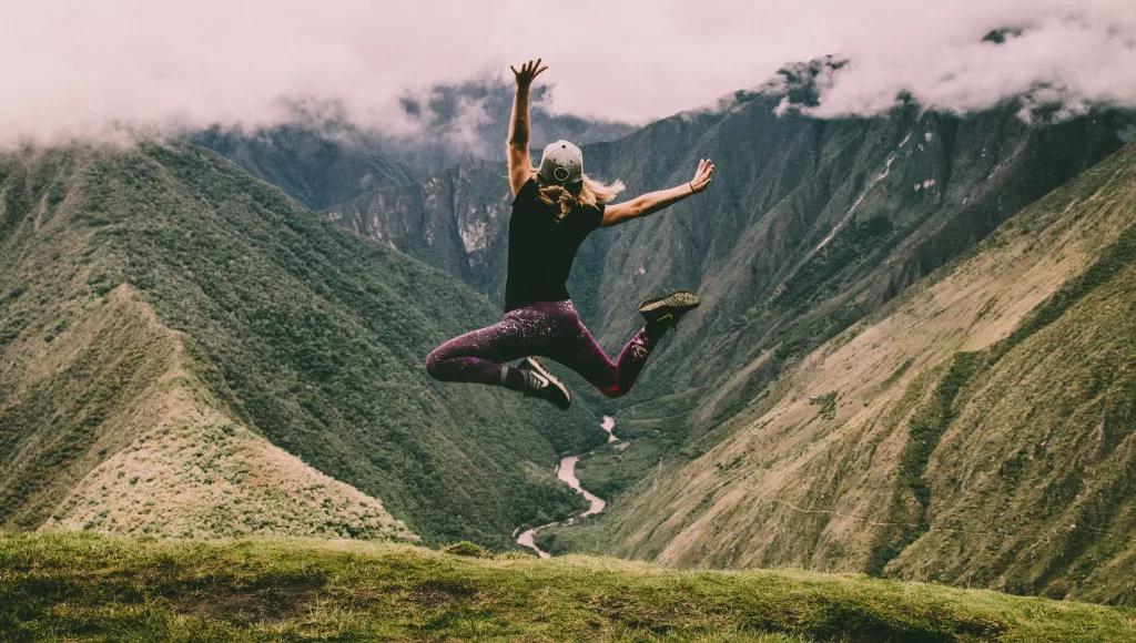 Woman jumping mountains