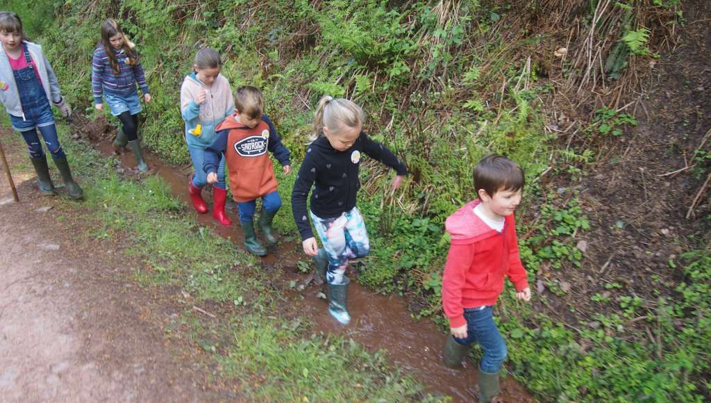 Families Together holiday children walking through a puddle