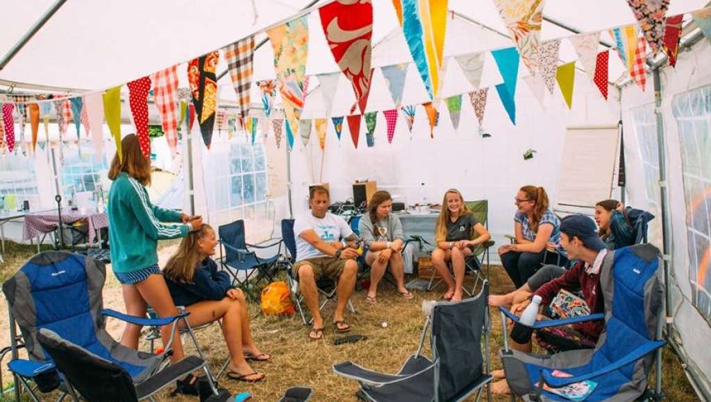 SU holiday at Do The Impossible festival. Young people meeting in a marquee.
