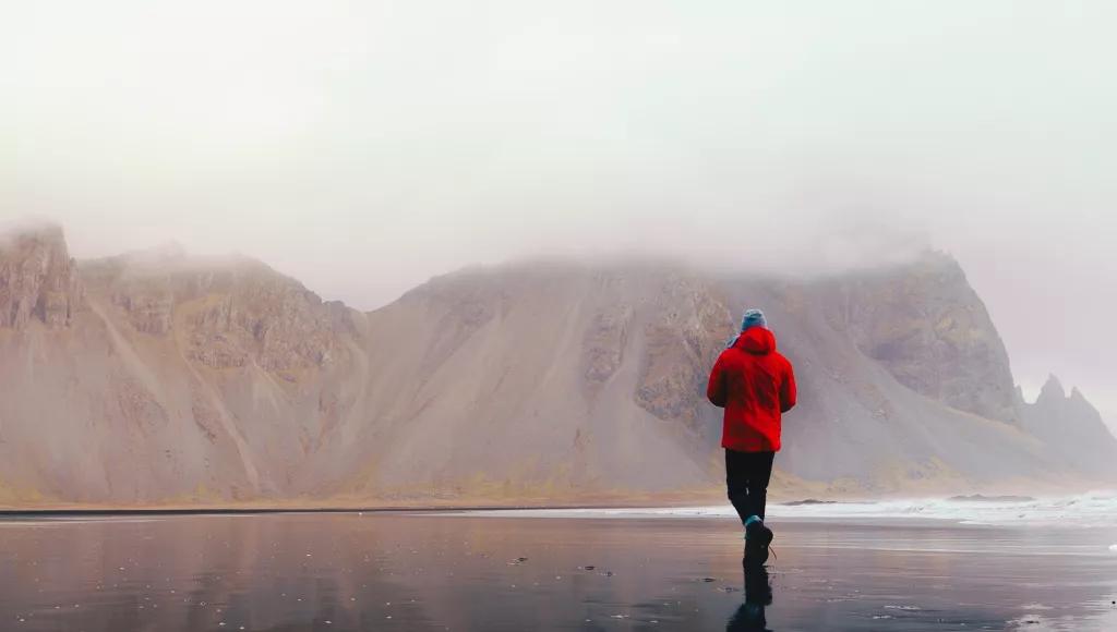 Man running beach mountains
