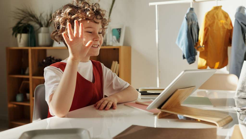 Child smiling using tablet