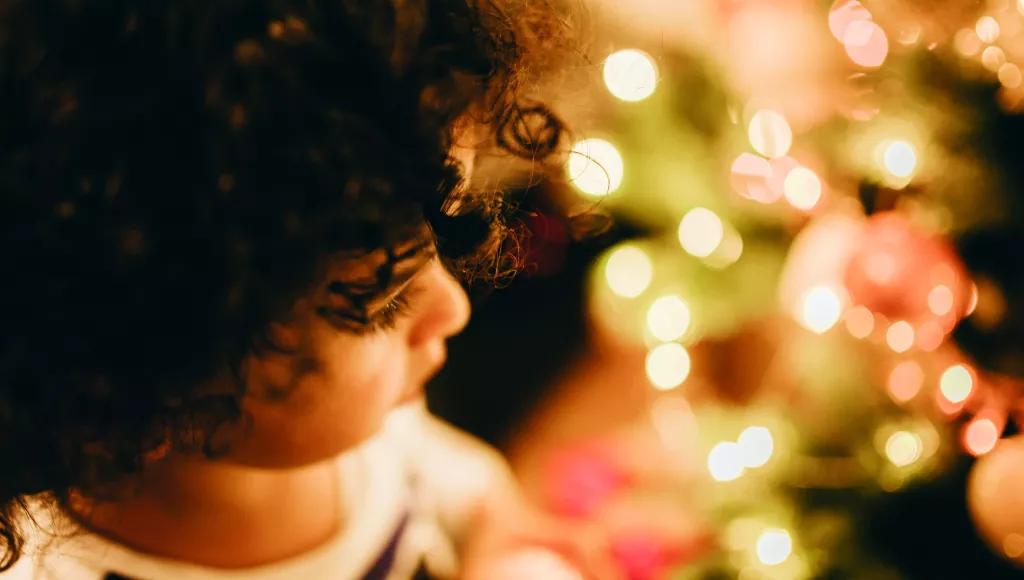 Young child with Christmas lights