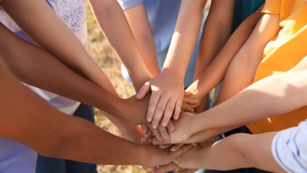 children hands on top of each other