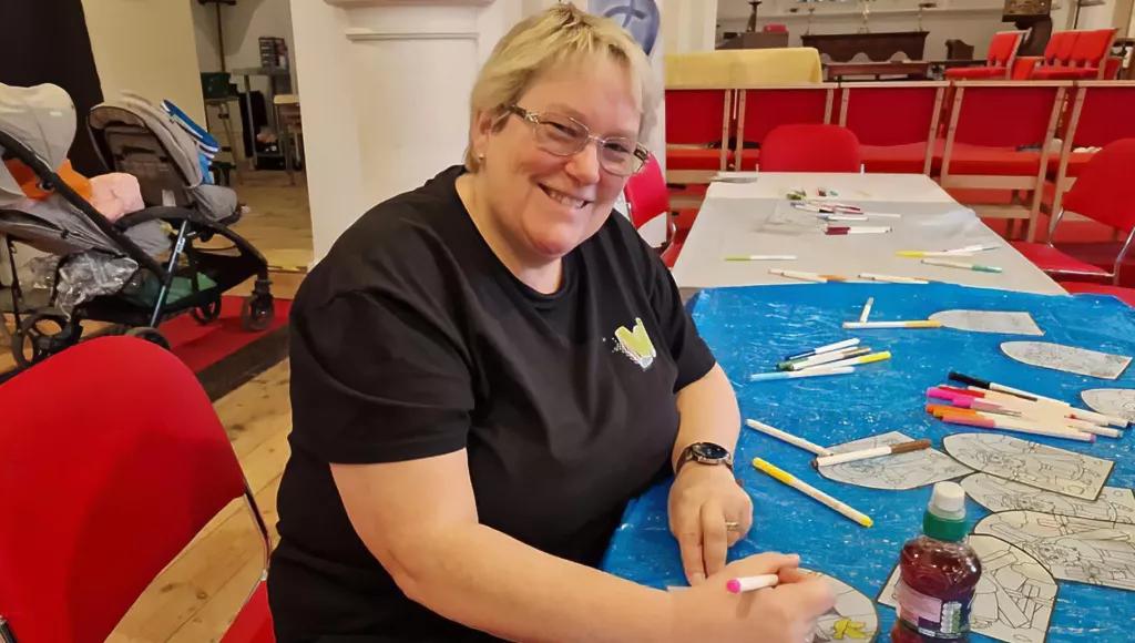 Carolyn working at the craft table