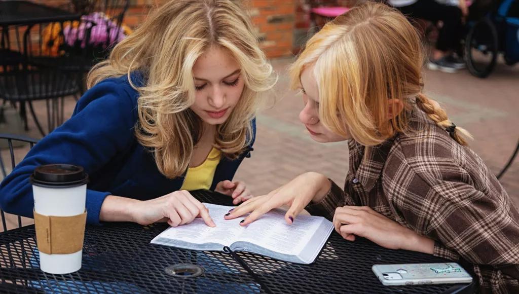 Teenage girls reading Bible