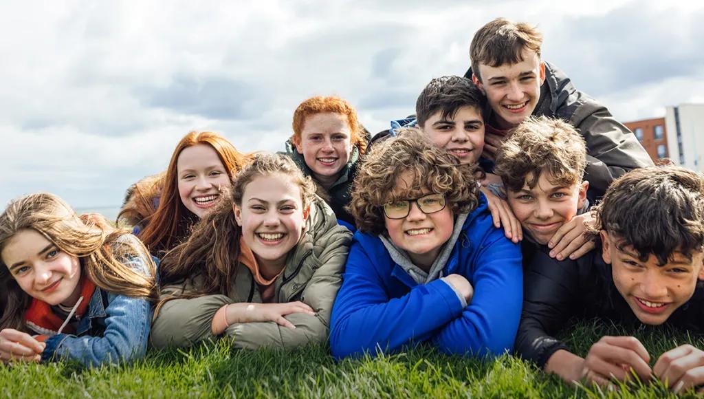 Group of teenagers laying on the grass