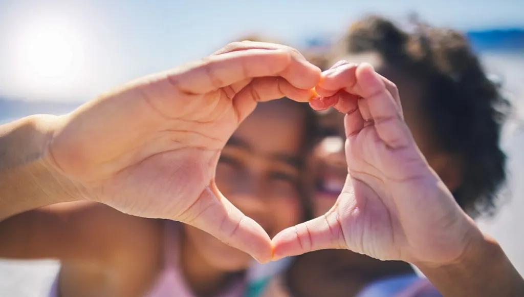 Children making a heart with their hands