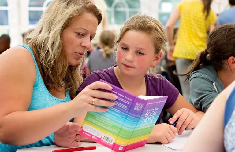 Child and Adult Reading the Bible