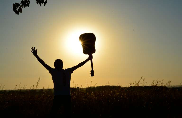 Young person with arms raised in celebration