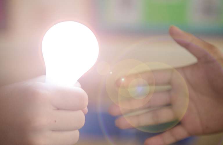 Shine in Schools Light bulb being handed over