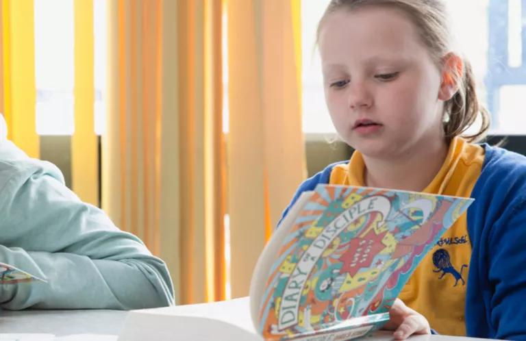 School children reading Diary of a Disciple