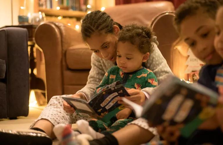 Children reading God Became Like Me