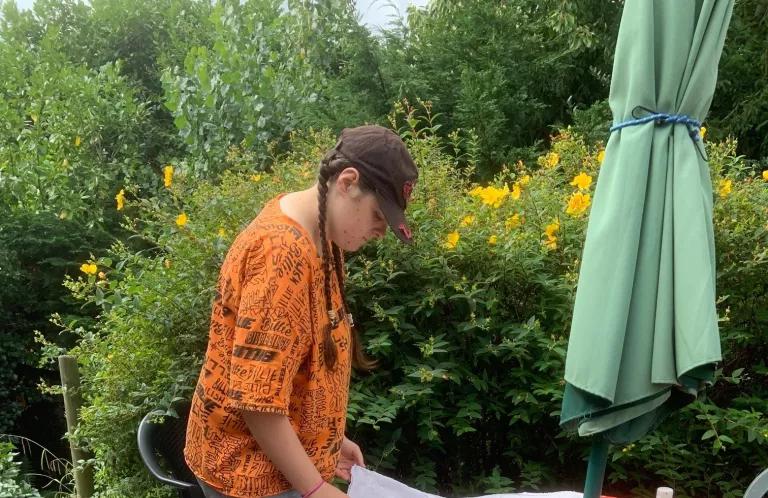 Female doing art in a garden 