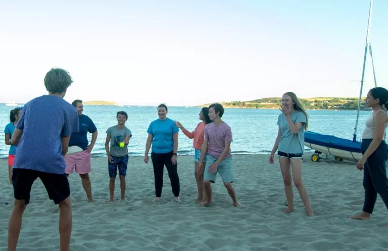 young people playing on beach