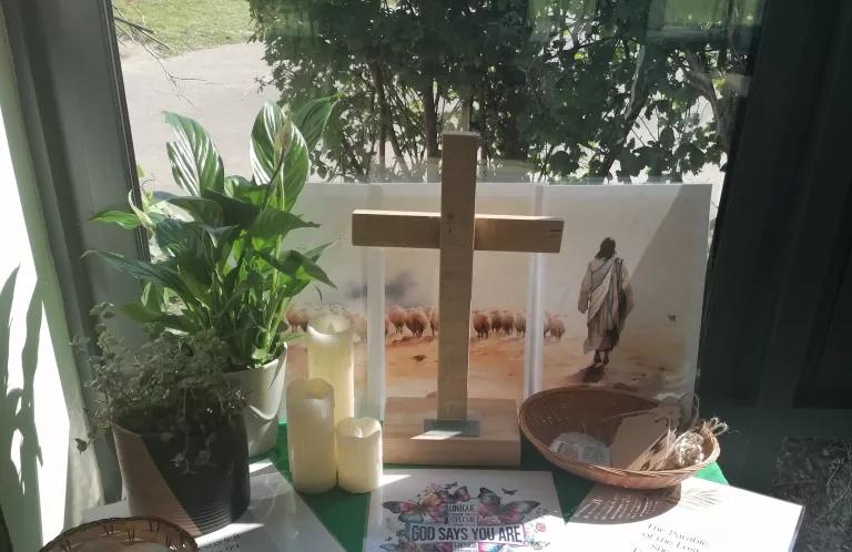 wooden cross and other creative prayer prompts on a table
