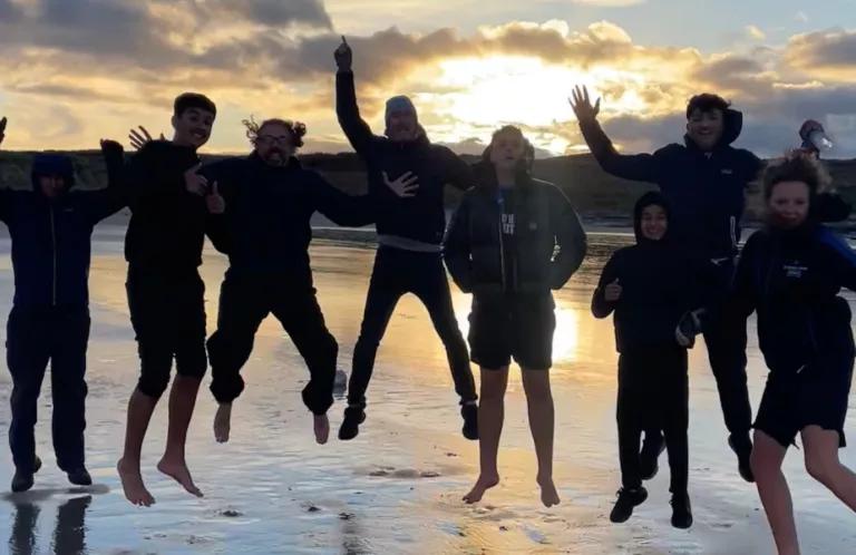Group pf young people jumping on the beach