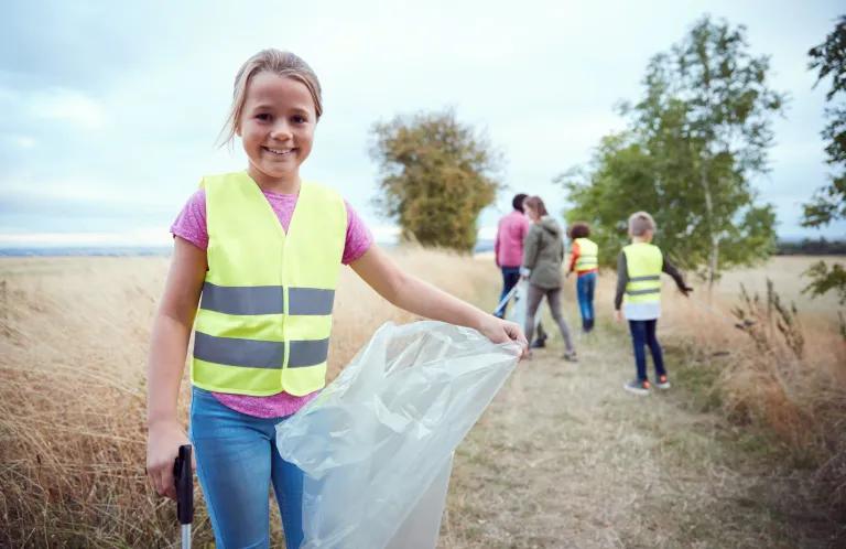 Child holding bag for litter picking