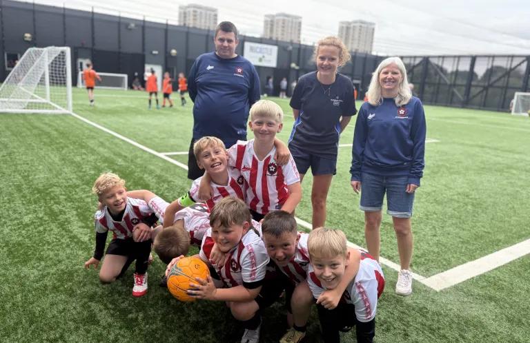 Sarah, Jen and the team with a football