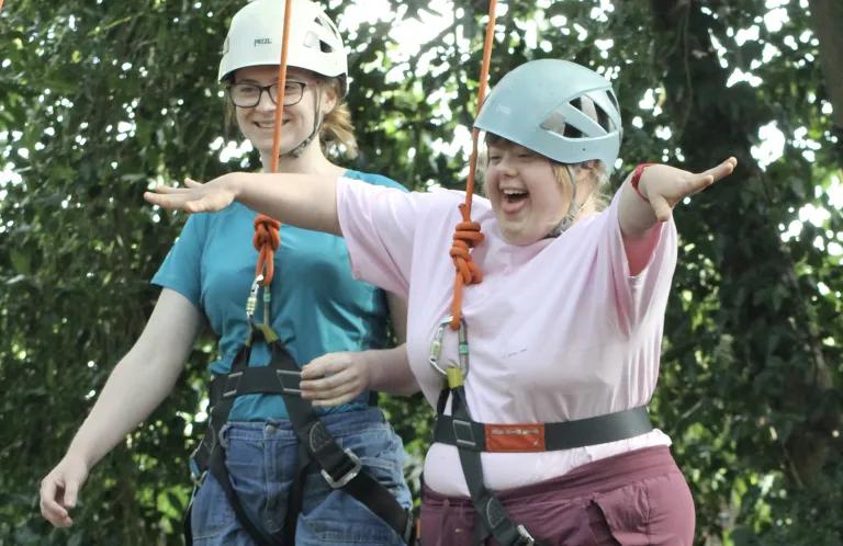 A young woman does a high ropes course