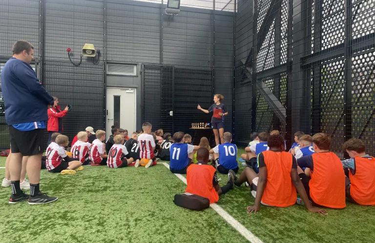 Sarah shares with a group of kids