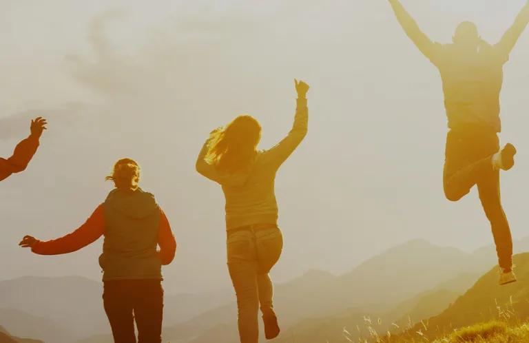 Teenagers jumping at sunset