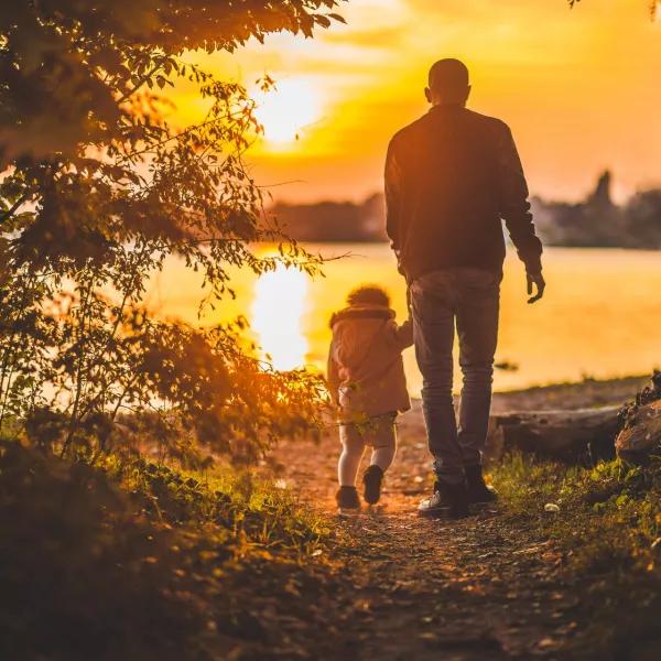 Adult and child holding hands