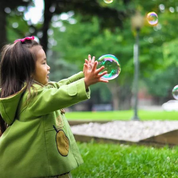 Girl chasing bubbles