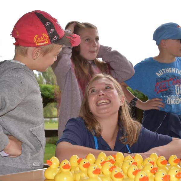 Volunteer laughs as children have fun