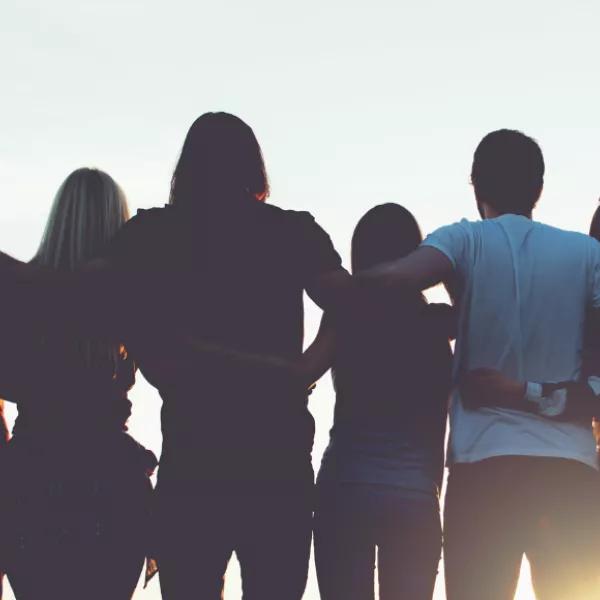 Young people with arms around each other
