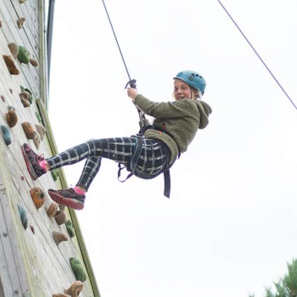 Young person scaling the heights