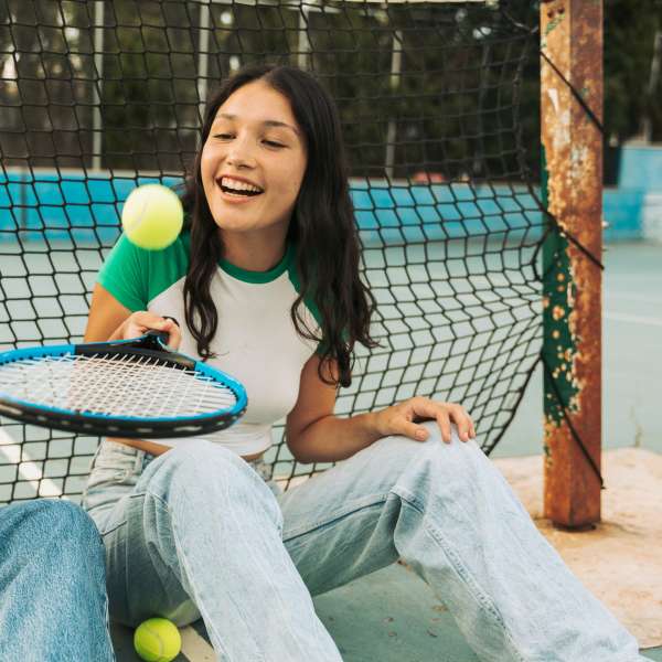 Girl bouncing tennis ball
