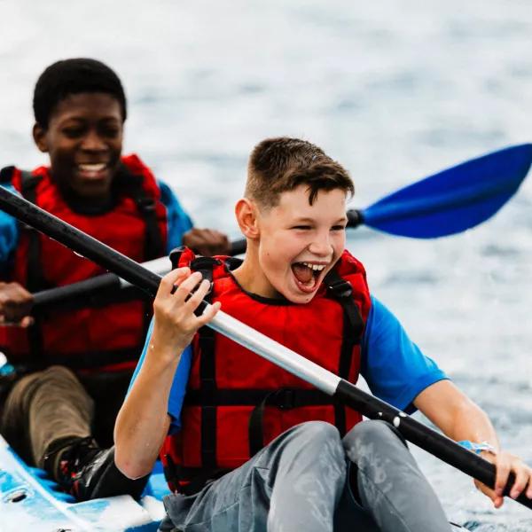 Boys on canoe laughing