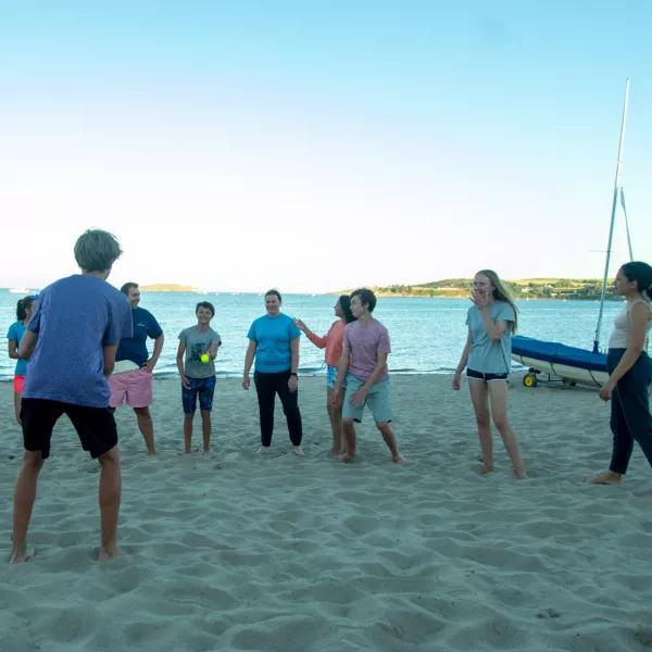 young people playing on beach